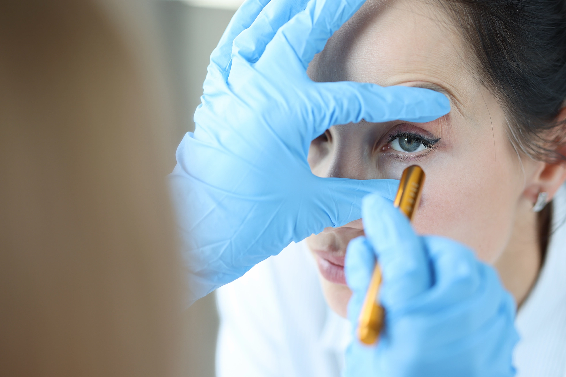 A patient experiencing sudden blurry vision having her eyes checked 
