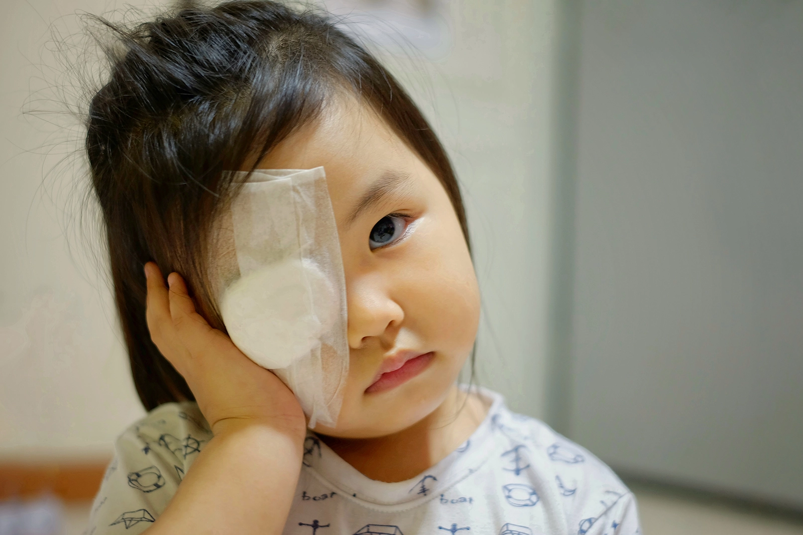 Child using eye patching to treat strabismus
