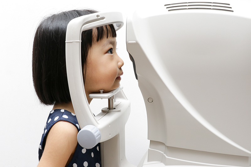 Young girl undergoing an eye check for myopia control.